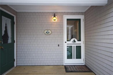 Covered porch entrance. Left to...