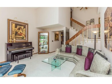 Another view of living room and open staircase