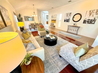 Living area featuring a chandelier, crown molding