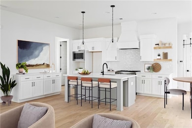 Kitchen featuring white cabinets, open shelves, a 