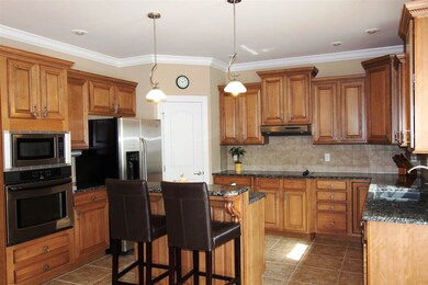 The large eat-in kitchen features beautiful cabine