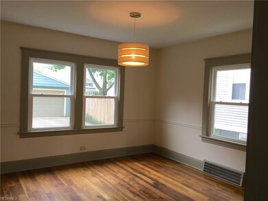 The bright dining room has original hardwood floors.  Windows in home were replaced in 2013.
