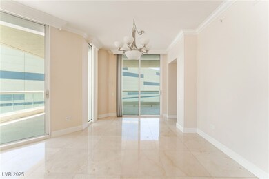 Spare room with a chandelier, crown molding, light
