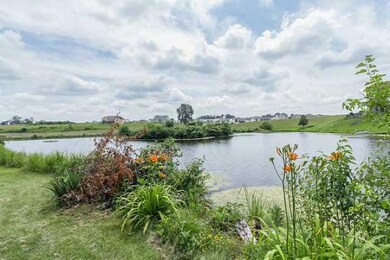 Exterior Front. Pond located behind the home.