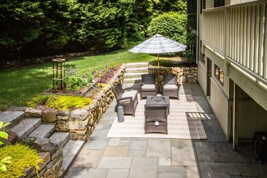 Lower level private patio with fire pit and raised gardens