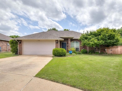 Single story home featuring brick siding, a garage, driveway, and a shingled roof