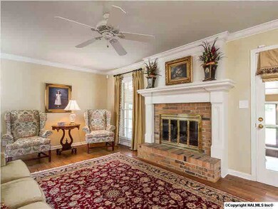 Family room features built-in bookcases, gas log fireplace, hardwood floors and doors to one of the prettiest screened porches in Blossomwood.