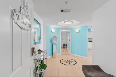 Hall with light tile patterned flooring and a text