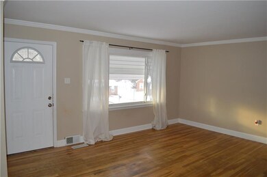 Living room with lots of natural lighting and hardwood flooring