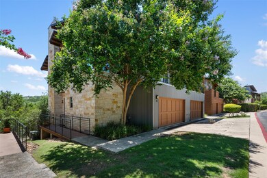 View of property exterior with stone siding, a ga