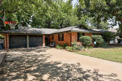 Ranch-style home featuring a front lawn and a gara