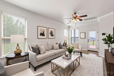 Living area with crown molding, wood finished flo
