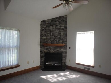 Living Room. A FLOOR-TO-CEILING STONE FIREPLACE IS