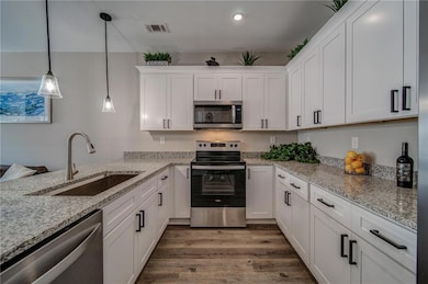 Kitchen with stainless steel appliances, a sink, w