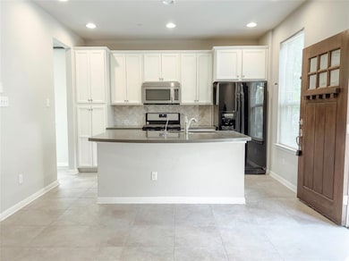 Kitchen with stainless steel appliances, tasteful