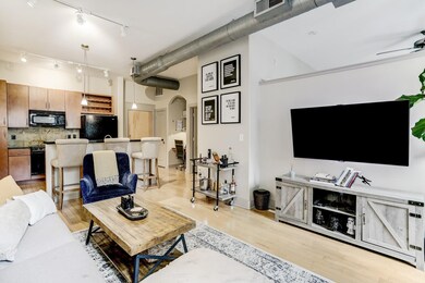 View from living towards the kitchen. Notice the beautiful hardwood floors and natural sunlight.