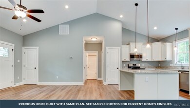 Kitchen with white cabinetry, a center island, cei