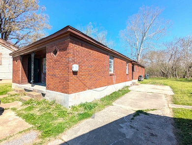 View of side of property featuring brick siding