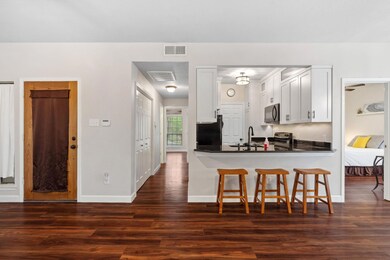 Kitchen featuring dark wood-style flooring, black