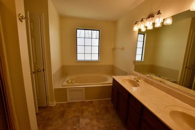 Master bath has separate bath and shower with double vanities.