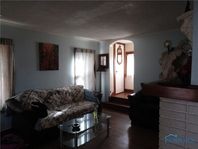 living room leading to stairway to second floor
