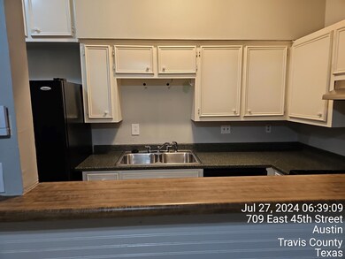 Kitchen featuring a sink, freestanding refrigerat