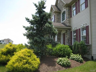 Lush landscaping enhances front of the house.