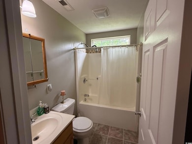 Full bath with toilet, shower / bath combo, and vanity