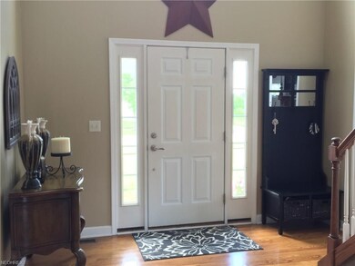 Front entry door has  side glass panel windows and