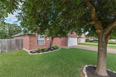 Obstructed view of property featuring brick siding