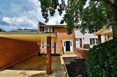 View of front facade with brick siding and an attached carport