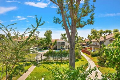 Picturesque views of the lush grounds, mature trees, and the community pool