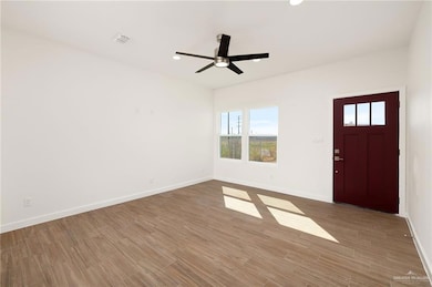Entrance foyer featuring wood finished floors, ceiling fan, and recessed lighting