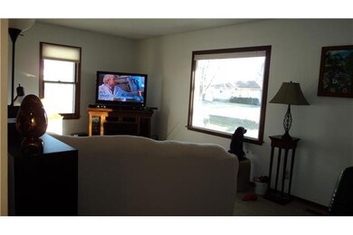 Living Room. Berber Carpeting & Large Picture Wind