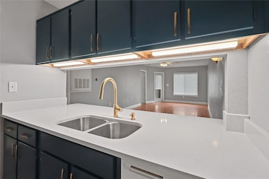 Beautiful sea blue cabinets with burnished brass f
