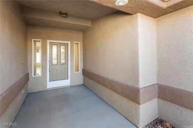 View of exterior entry featuring stucco siding