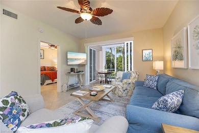 Tiled living room featuring ceiling fan