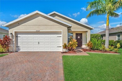 Single story home with decorative driveway, stucco siding, a front yard, and a garage