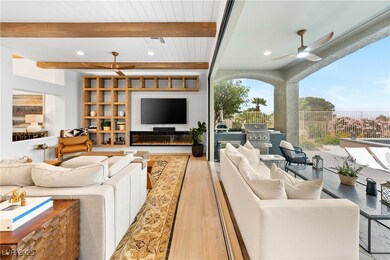 Living area featuring ceiling fan, wood finished f