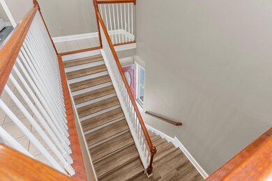 Stairway featuring wood-type flooring