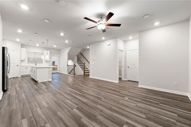 Unfurnished living room with dark hardwood / wood-style flooring and ceiling fan