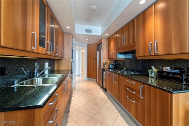 Kitchen featuring brown cabinetry, a sink, stainle