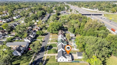 Aerial overview of property's location featuring nearby suburban area and a tree filled landscape