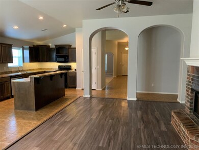 Living room view to kitchen and entry hall