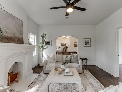 Living area with ceiling fan with notable chandeli