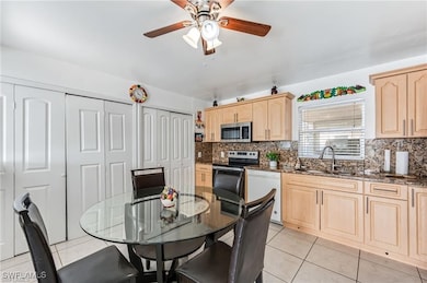 Kitchen featuring light brown cabinetry, dishwashe