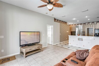The FAMILY ROOM opens to the KITCHEN and is perfec