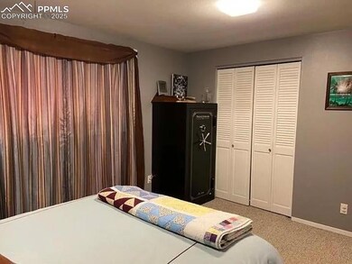 Bedroom with light carpet, and a closet
