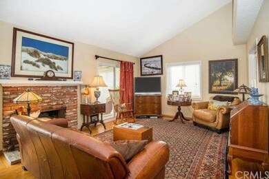 A cozy brick fireplace is the focal point of the L