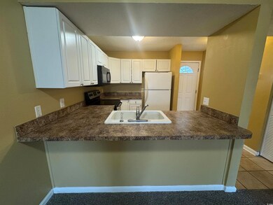 Kitchen with electric range, freestanding refriger